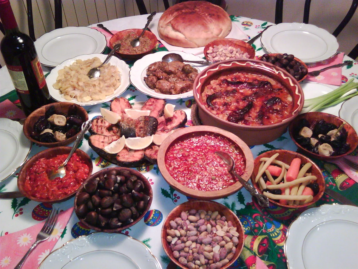 A Christmas dinner table laid with festive dishes