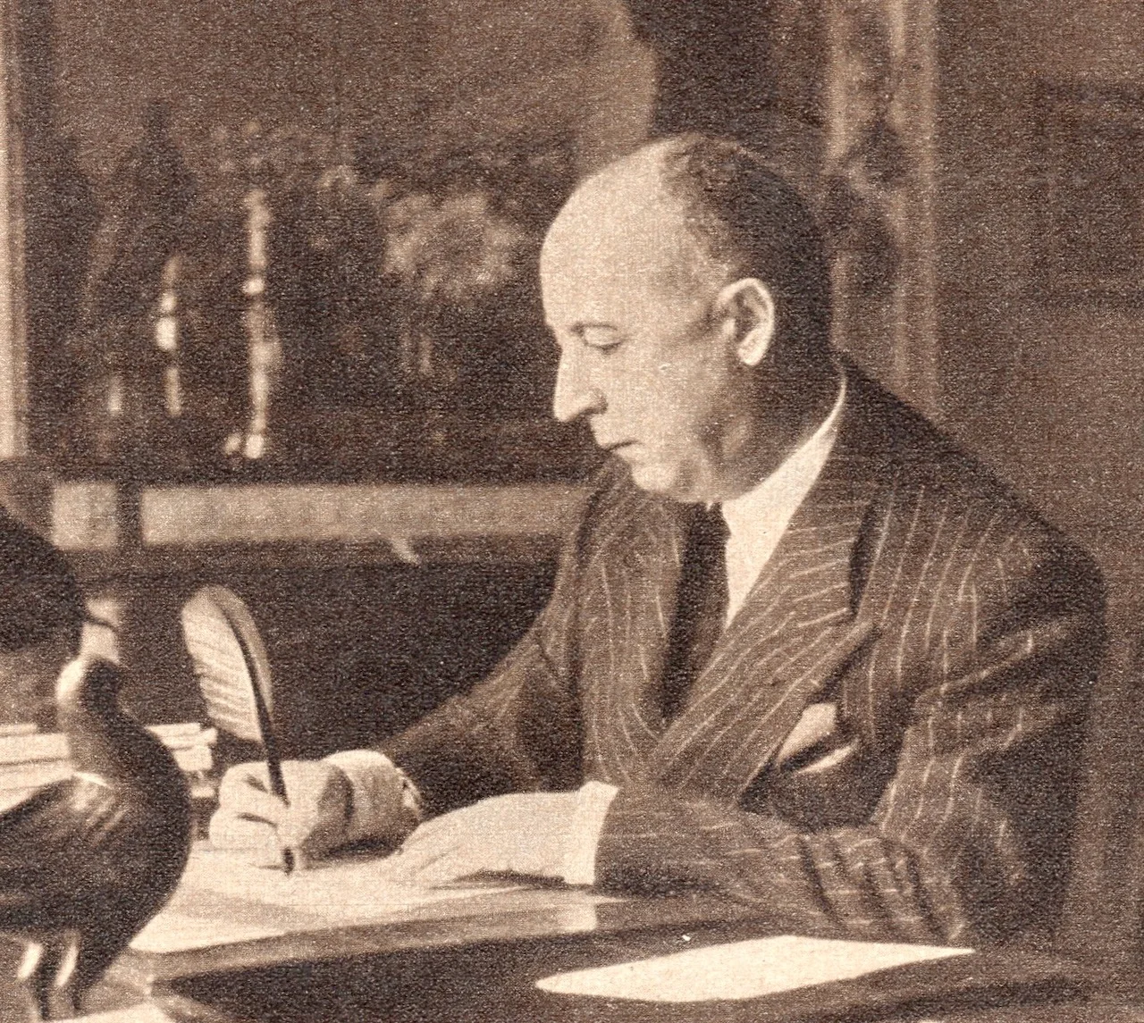 Christian Dior writing at his desk, 1954