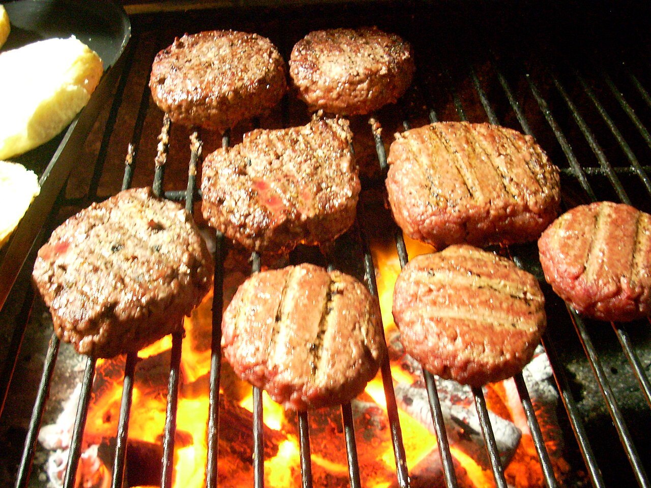 Hamburger patties cooking on a grill