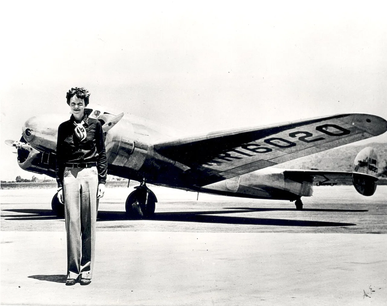 Amelia Earhart standing in front of her Lockheed Electra, the aircraft in which she disappeared in 1937