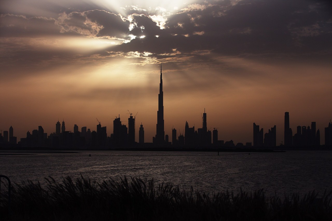 The Burj Khalifa and Dubai skyline silhouetted at sunset