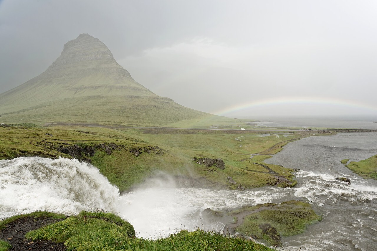 Kirkjufell mountain and Kirkjufellsfoss waterfall under a faint rainbow, Iceland